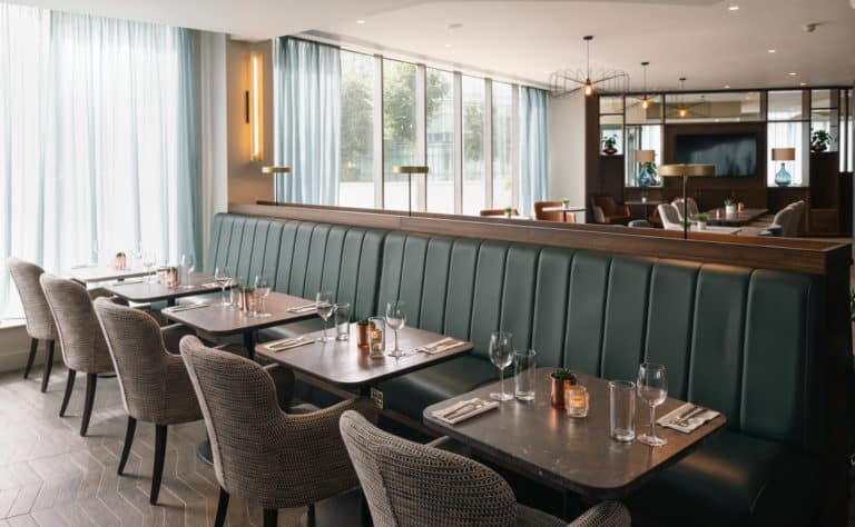 Aspect Hotel Park West Dining Area With Comfy Couches and tables set for dinner