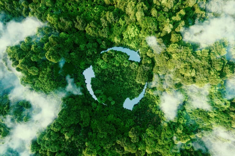 Aerial shot of green forest with recyling logo